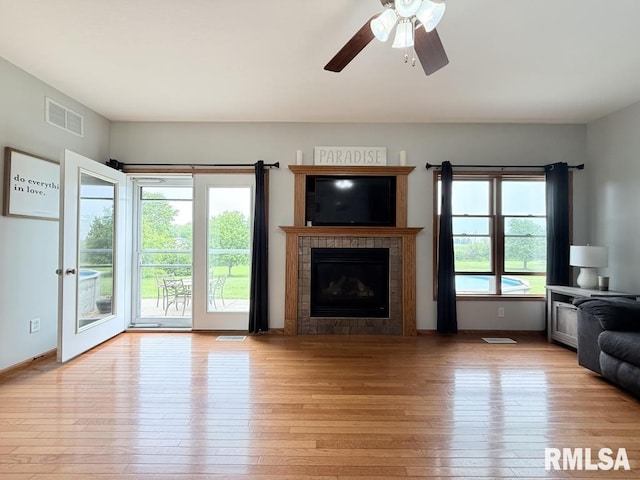 418 Michelle Ln, Walcott, IA 52773 - living area featuring a tile fireplace, light wood-style floors, and ceiling fan