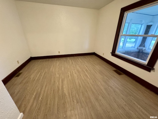 1100 E 2nd St, Centralia, IL 62801 - empty room with wood finished floors and baseboards