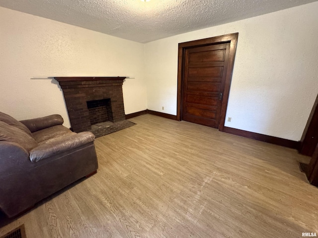 1100 E 2nd St, Centralia, IL 62801 - living room with wood finished floors, a textured ceiling, and a fireplace