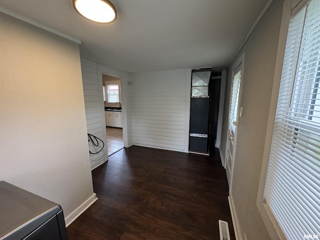 1307 S Maple St, Centralia, IL 62801 - hall with dark wood finished floors, wood walls, heating unit, and crown molding