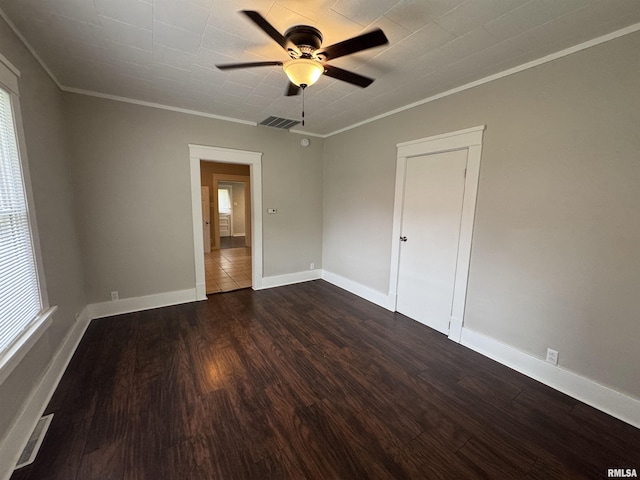 1307 S Maple St, Centralia, IL 62801 - empty room featuring a ceiling fan, ornamental molding, dark wood-style floors, and healthy amount of natural light