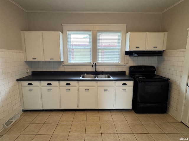 1307 S Maple St, Centralia, IL 62801 - kitchen with black electric range oven, tile walls, dark countertops, white cabinets, and ornamental molding