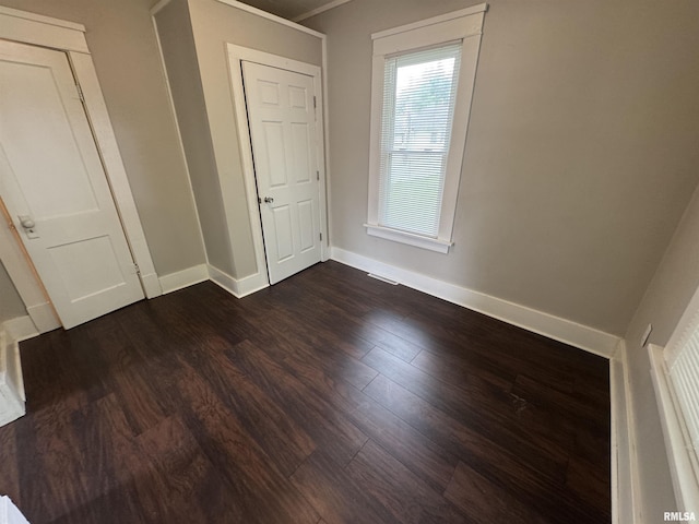 1307 S Maple St, Centralia, IL 62801 - unfurnished bedroom with baseboards and dark wood-style floors