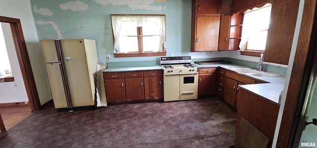 232 N James Ave, Centralia, IL 62801 - kitchen with white appliances, light countertops, brown cabinetry, and healthy amount of natural light