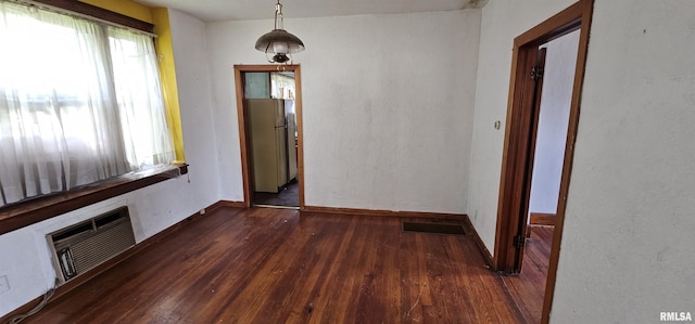 232 N James Ave, Centralia, IL 62801 - unfurnished dining area with hardwood / wood-style flooring and an AC wall unit
