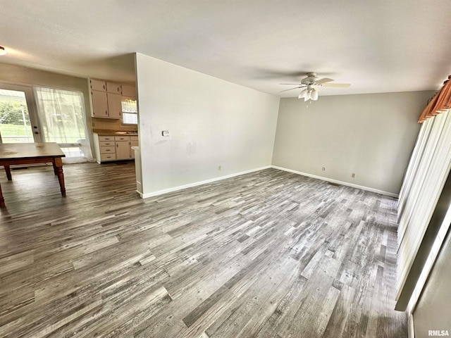 6 Charles Dr, Centralia, IL 62801 - unfurnished living room featuring a ceiling fan, dark wood-style floors, and plenty of natural light