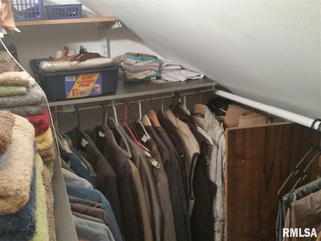 walk in closet featuring lofted ceiling