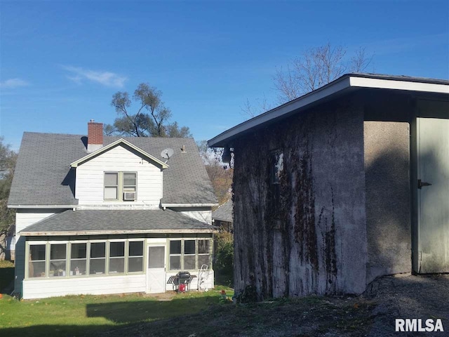 back of property featuring a sunroom