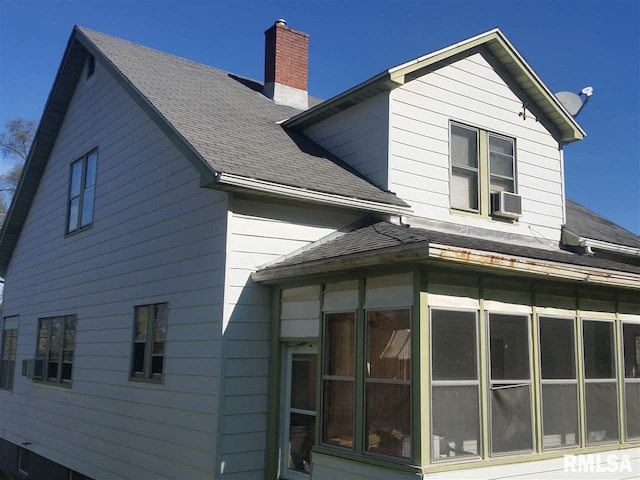 back of house with a sunroom