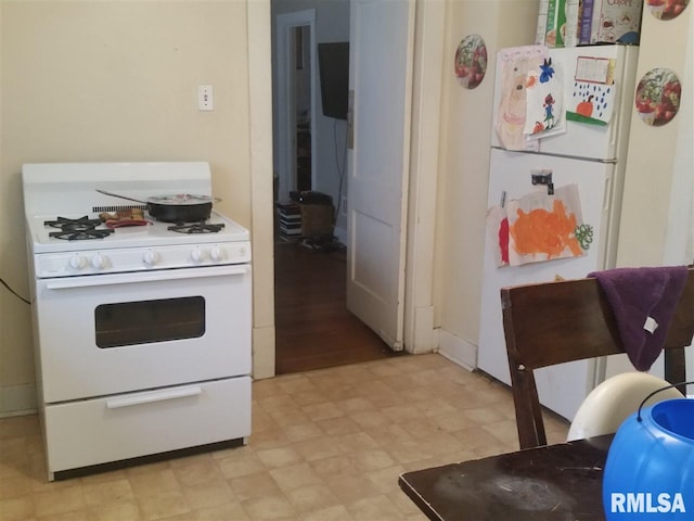 kitchen with white appliances and light tile floors