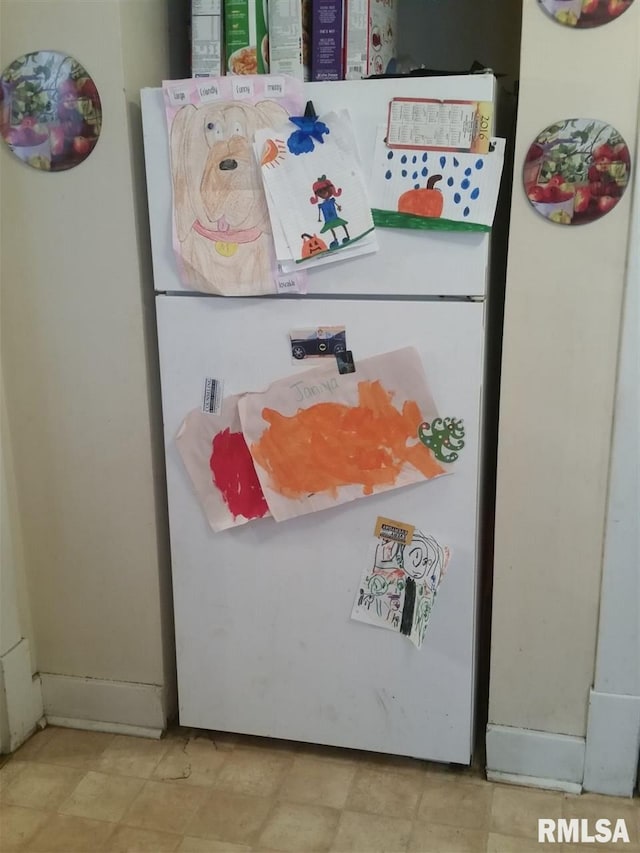 room details with light tile flooring and white fridge