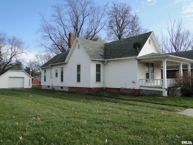 view of front of property with a front yard, an outdoor structure, covered porch, and a garage