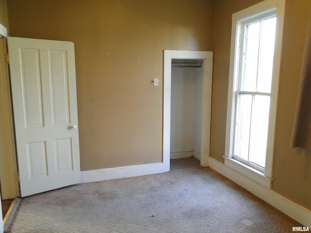 unfurnished bedroom featuring light carpet