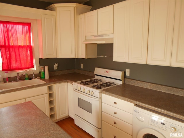 kitchen featuring washer / clothes dryer, white cabinets, premium range hood, and white gas stove