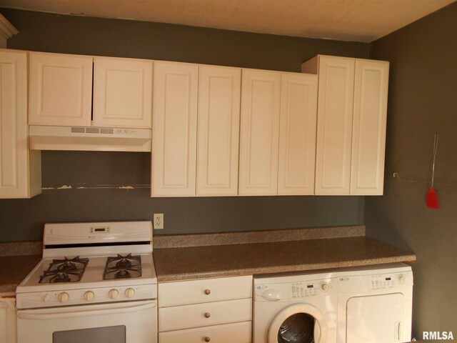 kitchen with washing machine and clothes dryer, range, and white cabinets