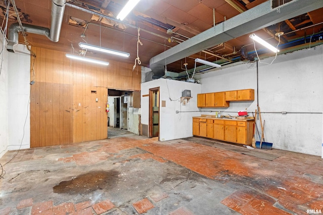 basement featuring wood walls