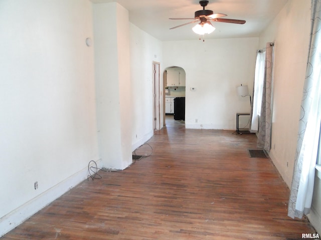 empty room with ceiling fan and dark wood-type flooring