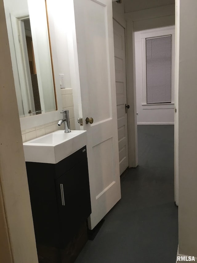 bathroom with concrete floors and vanity