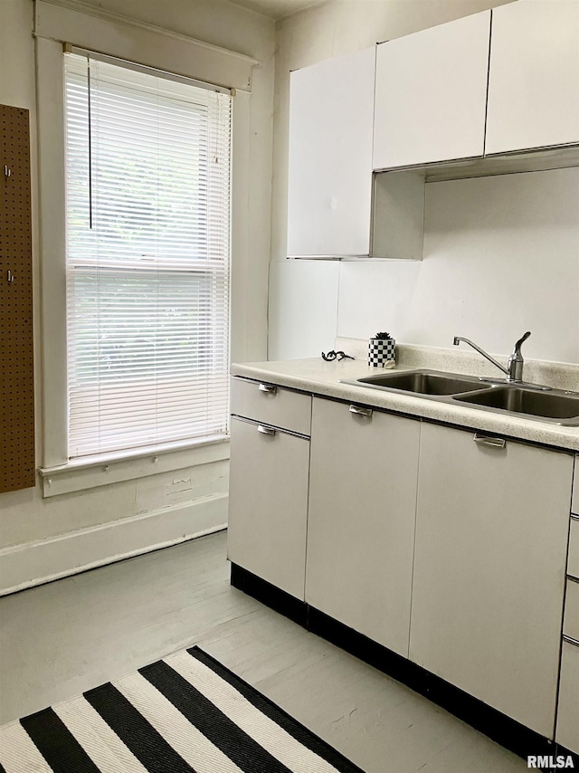 kitchen with sink and white cabinetry