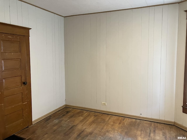 unfurnished room with dark wood-type flooring