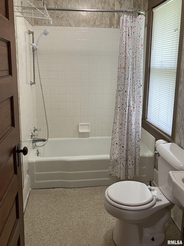 bathroom featuring shower / bath combo and toilet