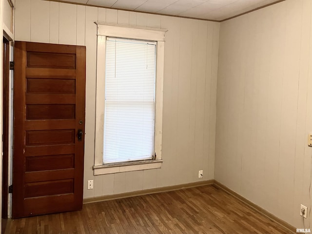 interior space with wood-type flooring and ornamental molding