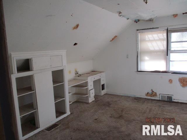 bonus room with carpet floors and lofted ceiling