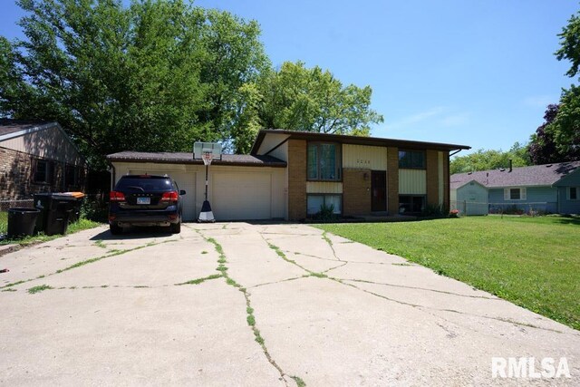 view of front of property featuring a garage and a front lawn