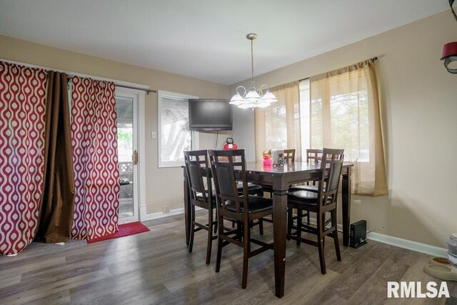 dining room featuring dark wood-type flooring and a chandelier