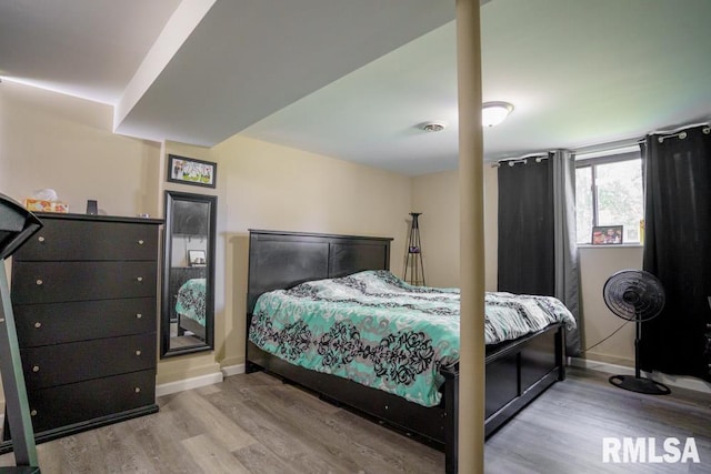 bedroom featuring hardwood / wood-style floors and a closet