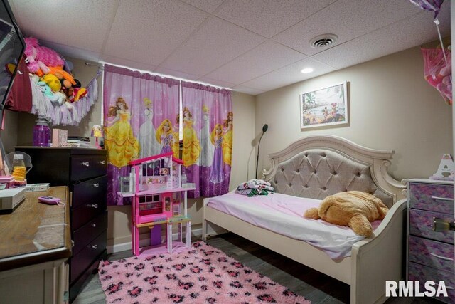 bedroom with a paneled ceiling and carpet