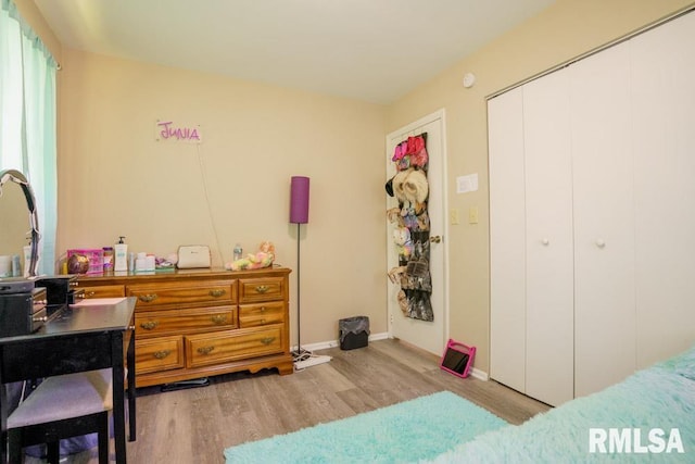 bedroom with hardwood / wood-style floors and a closet