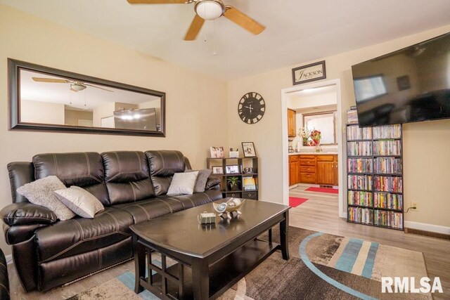 living room with hardwood / wood-style floors and ceiling fan