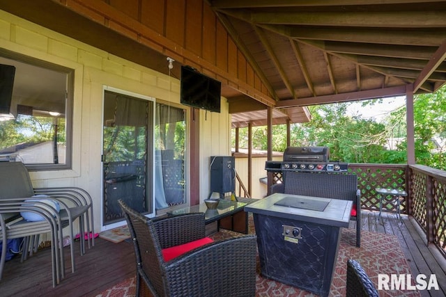 wooden deck featuring a fire pit