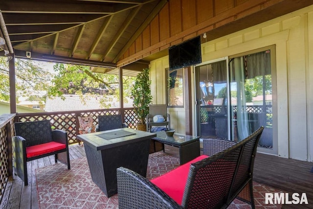 wooden deck with an outdoor living space with a fire pit