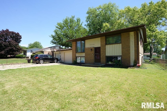 split foyer home with a garage and a front lawn