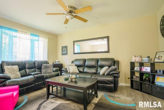 living room with light wood-type flooring and ceiling fan