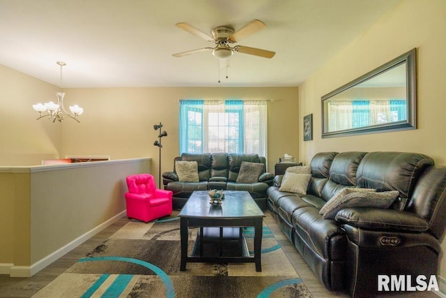 living room with hardwood / wood-style flooring and ceiling fan with notable chandelier