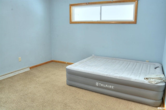 bedroom featuring baseboard heating and light carpet