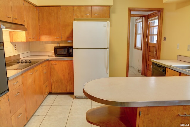 kitchen with black appliances, light tile patterned floors, and tasteful backsplash