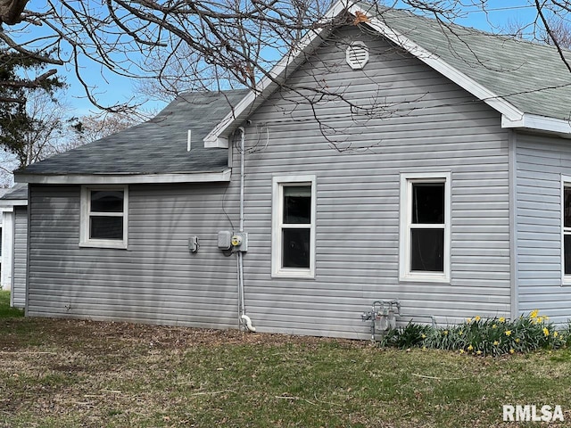 view of side of home featuring a lawn