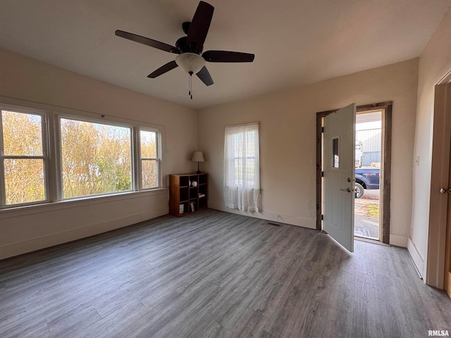 unfurnished living room with hardwood / wood-style floors and ceiling fan