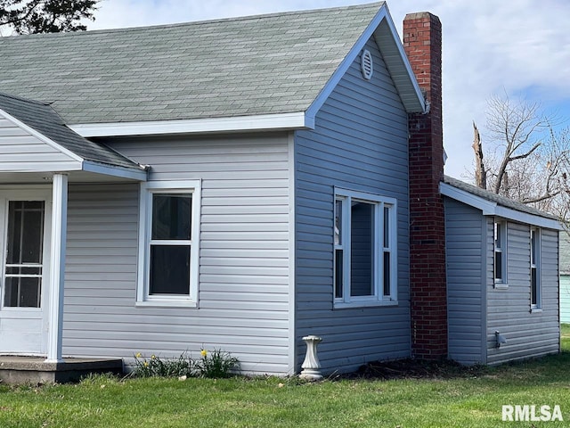 view of side of home featuring a yard