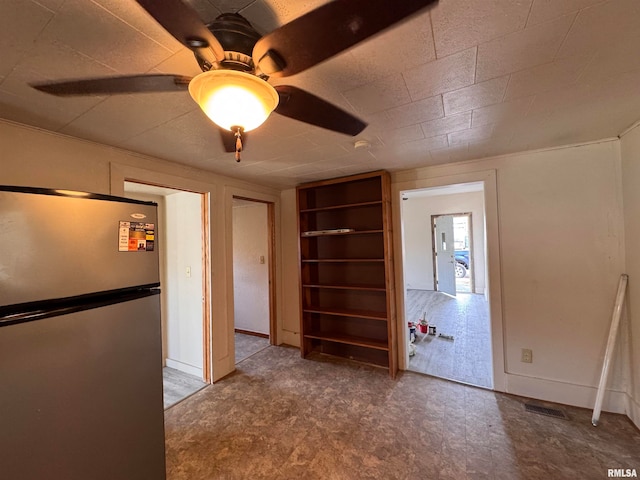 unfurnished room featuring ceiling fan