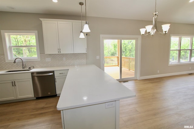 kitchen with dishwasher, sink, decorative light fixtures, decorative backsplash, and white cabinets