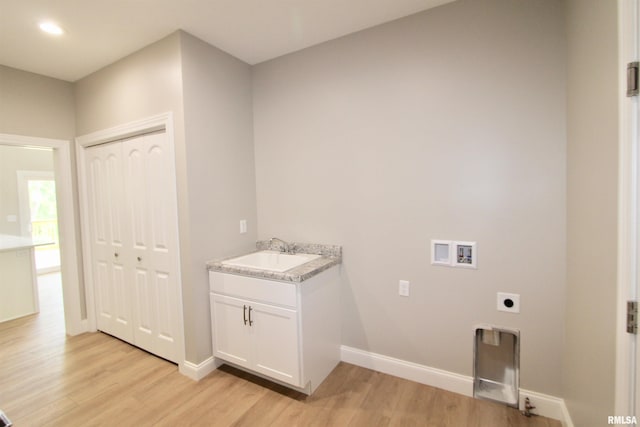 washroom featuring hookup for an electric dryer, light wood-type flooring, sink, and washer hookup