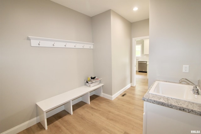 mudroom with light hardwood / wood-style floors and sink