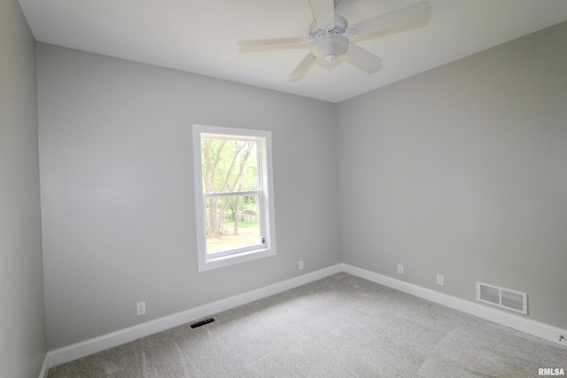 carpeted empty room featuring ceiling fan