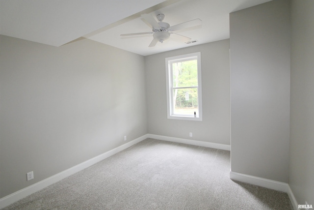 spare room featuring carpet floors and ceiling fan