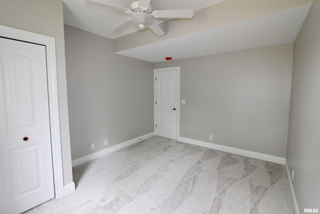 unfurnished bedroom with light carpet and ceiling fan